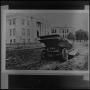 Photograph: [Car stuck in mud in front of the Library Building]