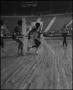 Photograph: [Basketball Players Running Along Court During Game]