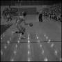 Photograph: [Basketball player dribbles down the court]