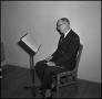 Photograph: [Maurice McAdow sitting in a chair, 6]