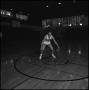 Photograph: [Basketball hunched over and dribbling ball]