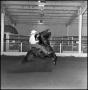 Photograph: [Close up of cowboy riding in the Cutter Bill Arena]