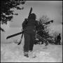 Photograph: [Woman carrying skis and poles]