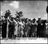 Photograph: [Crowd of spectators watching behind a fence]