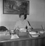 Photograph: [Dr. Irma Canton sitting behind her desk]