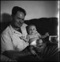 Photograph: [Joe Clark and Junebug on a couch, 6]