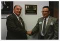 Photograph: [David Owsley and Dr. Robert La Forte shaking hands]