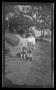 Photograph: [John and Byrd Williams, III, standing on a sidewalk]