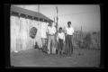 Primary view of [Byrd III, Charles, and John Williams in a backyard]