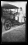 Photograph: [Irene Williams posing next to a Model T]