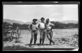 Photograph: [Three men standing and posing in a desert]