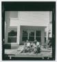 Photograph: [Portrait of a family on their porch]