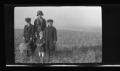 Photograph: [The Williams family standing in a field]