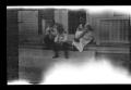 Photograph: [Irene Williams sitting on a porch with her sons]