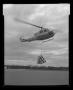 Photograph: [The XH-40 # 3 in flight with a cargo sling]