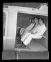 Photograph: [Service men seated in the cabin of the YH-40]