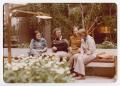 Photograph: [A Group Sitting Outdoors in a Garden Area]