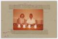 Photograph: [Man and Woman Seated with Cups]