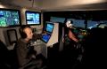 Photograph: [Three pilots in a flight simulator pod]
