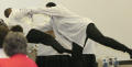 Photograph: [Costumed performers struggling in scene]