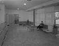 Photograph: [Woman in Hospital Reception Area]