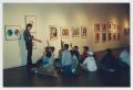 Photograph: [Teacher and Students Discussing Artwork]