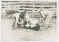 Photograph: [Three Cowhands Branding in Corral]