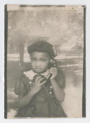Young girl holding telephone receiver