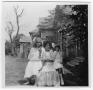 Photograph: Unidentified Woman and Two Unidentified Girls in Front of a Frame Hou…