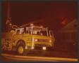 Primary view of [Fire engine parked in front of burning home]