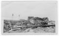 Photograph: [Damaged storage tank and debris after the 1947 Texas City Disaster]