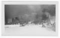 Photograph: [Smoke coming from the port area and refinery structures during the 1…