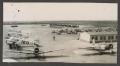 Photograph: [Airfield with Planes and Cars]
