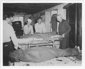 Primary view of object titled '[At the temporary morgue for victims of the 1947 Texas City Disaster]'.