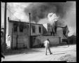 Photograph: [Man In Front of Burning Building]