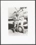 Photograph: [WASP with Parachute Standing by Plane]