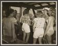 Photograph: [Group at Wheel in Boat Cabin]