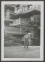 Photograph: [Woman in Front of Building]