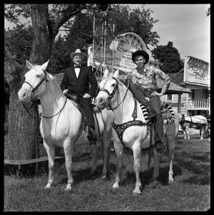 Primary view of object titled '[Bill Daniels and Hank Williams Jr. Riding Horses]'.