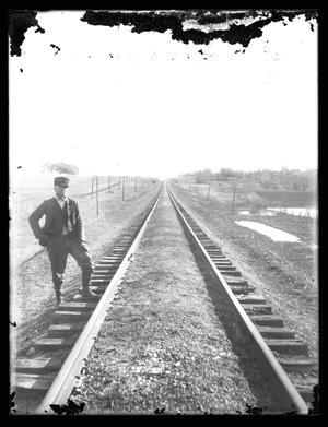 Primary view of object titled '[Man Posing by Railroad Tracks]'.