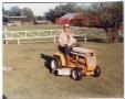 Photograph: [William Pate on Lawnmower With Grandson at Sunnyhill Ranch]