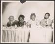 Photograph: [Four People Seated a Banquet Table]