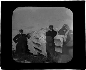 Primary view of object titled 'Glass Slide of Three people Standing by a Broken Column'.