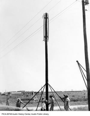 Primary view of object titled '[Men erecting telephone or power pole in Crestview neighborhood]'.