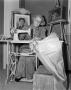 Photograph: [Lady Sewing on a Machine]