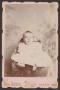 Photograph: [Photograph of a Small Unknown Baby in Light Clothing]