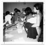Primary view of Nurse Oligar checking student immunization records