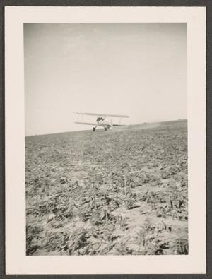 Primary view of object titled '[Biplane Taking Off from Dirt Strip]'.