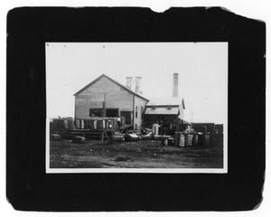 Primary view of object titled '[Bales of Hay in Front of Building]'.