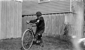 Primary view of object titled '[Child Standing With Bicycle]'.